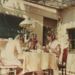 Bob Steffen, Thea Kuiper und deren Sohn am Tisch vor Ferienhaus von Bob Steffen in Begur oder Ascona, 1980