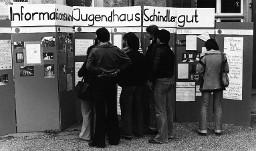 Jugendliche stehen vor einer mehrteiligen Stellwand mit Informationsaushang - "Informationswand Jugendhaus Schindlergut" - Hausfest 1977
