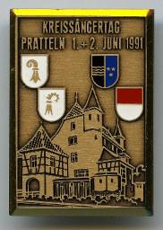 "Kreissängertag Pratteln, 1.+2. Juni 1991" – Bronzefarbenes Abzeichen aus Metall mit Schloss Pratteln und den Kantonswappen beider Basel, Aargau und Solothurn; vermutlich übersektionaler Anlass des Schweizerischen Arbeiter-Sängerverbands; 1991