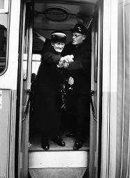 Kondukteur hilft betagter Frau beim Aussteigen aus einem Tram, um ca. 1950
